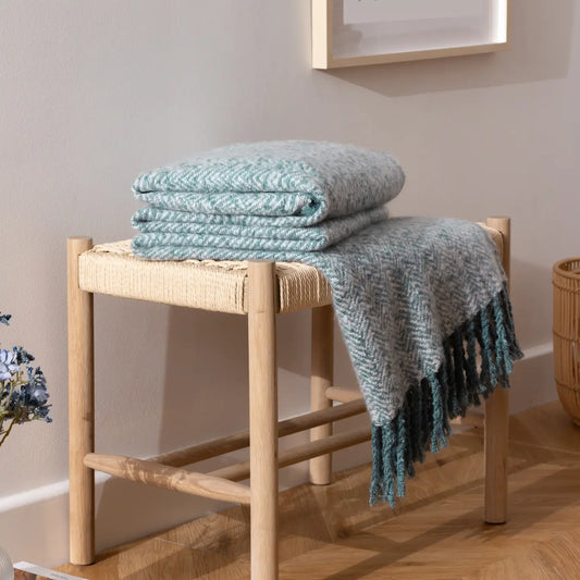 Herringbone print throw with soft textured finish, earth-toned colours, and 10cm tassel trim - cosy and versatile for rustic home décor.