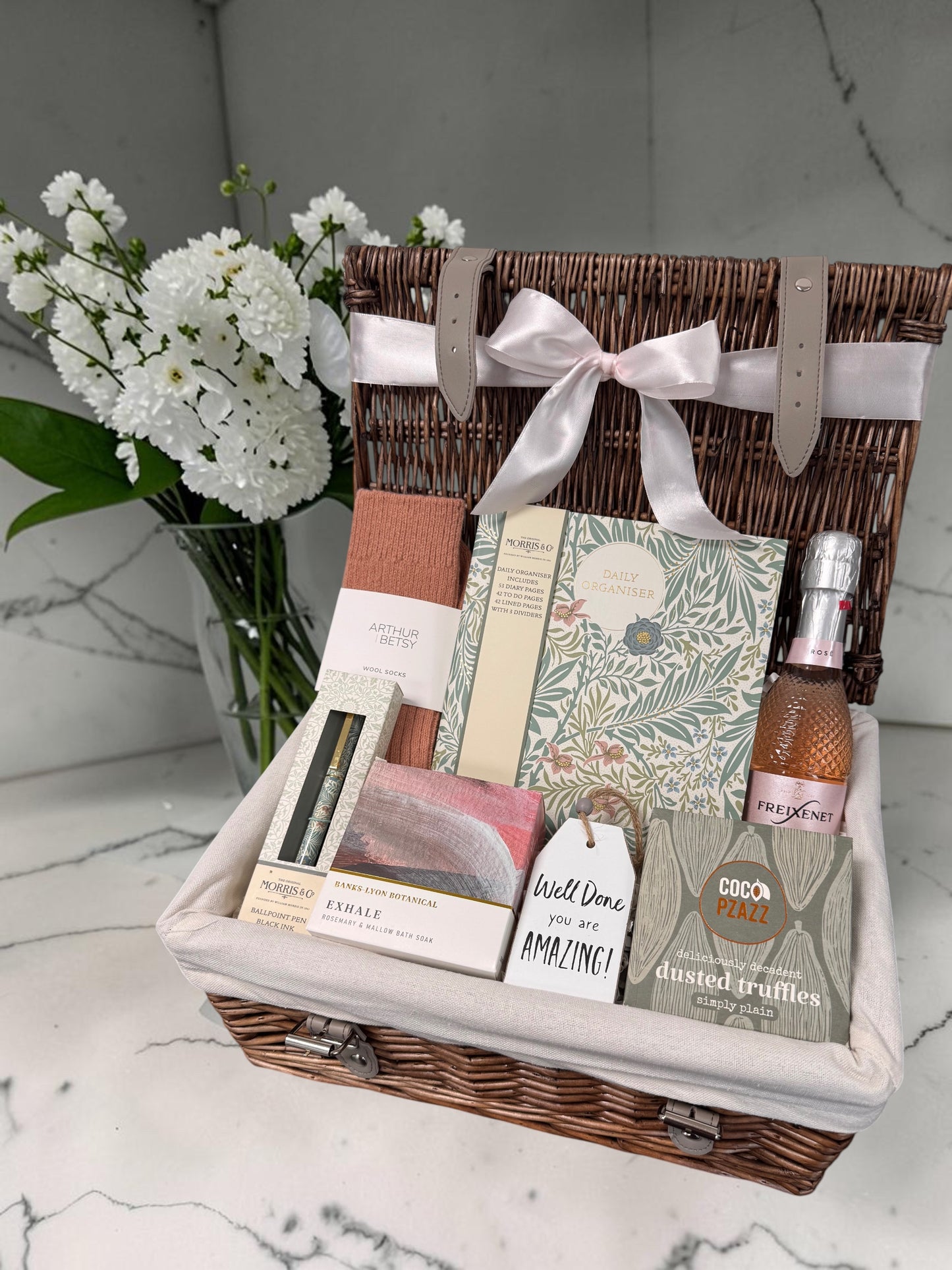 Well Done Gift for Her hamper with William Morris organiser pad, matching pen, Arthur Betsy socks, Exhale bath soak, sweet treats and celebratory drink.