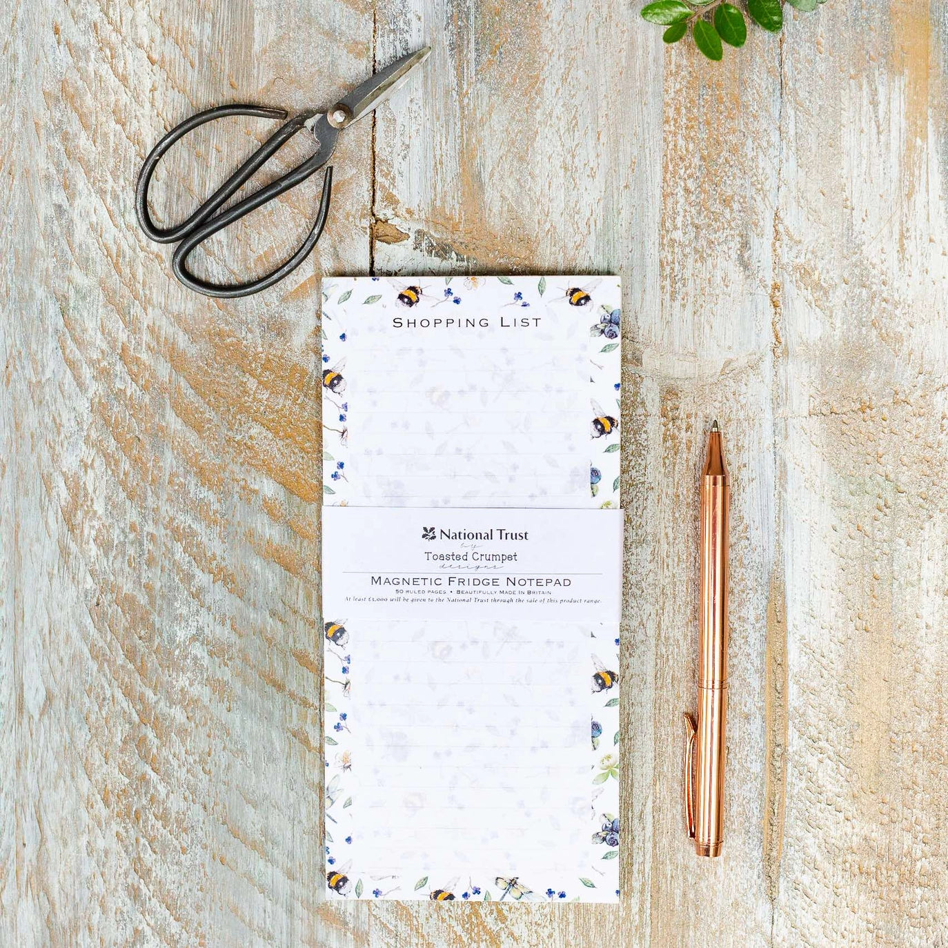 Wild flower meadow–design magnetic shopping list pad on desk.