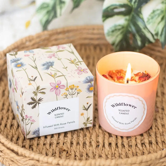 Wildflower candle in pink glass with rose petals, boxed for gifting.