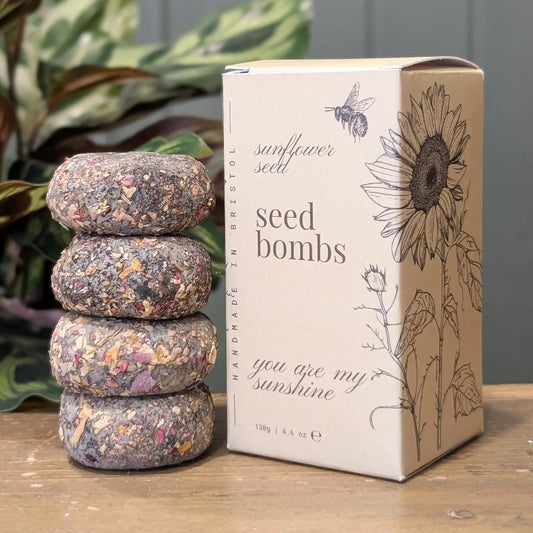 Handcrafted sunflower seed bomb made with natural clay and compost, designed to grow bright yellow sunflowers.