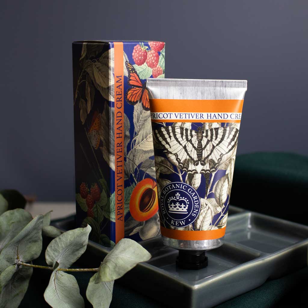 Luxurious Apricot Vetiver Hand Cream tube with botanical illustrations on a decorative box.