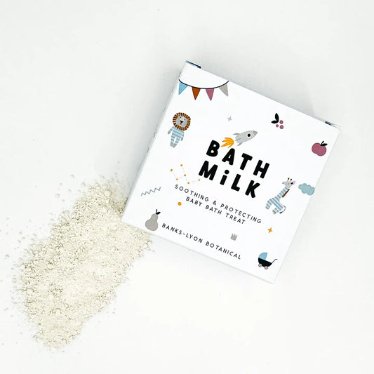 Gentle Baby Bath Milk packaging with spilled bath powder.