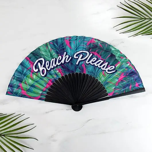 Colourful "Beach Please" hand fan with vibrant design for staying cool outdoors.