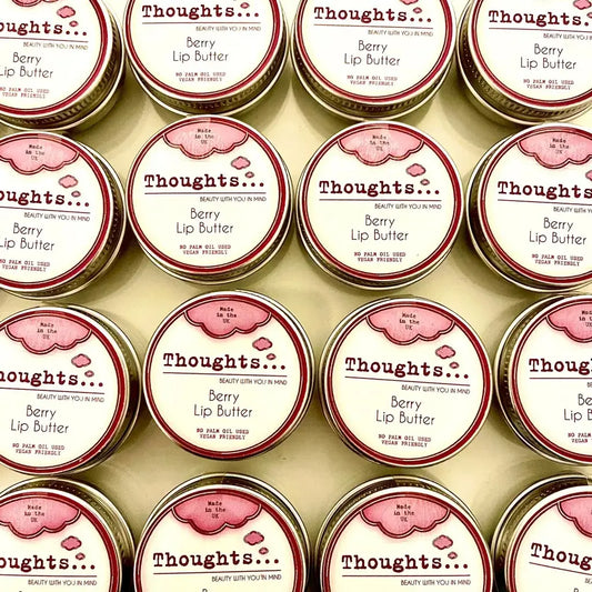Handmade vegan berry lip butter tins arranged neatly.