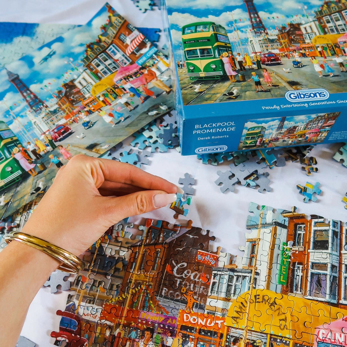 1000-piece Blackpool jigsaw puzzle illustrated by Derek Roberts showing Blackpool Tower, trams and lively seaside scenes.