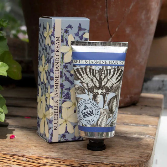 Hand cream and packaging with butterfly design on a wooden surface