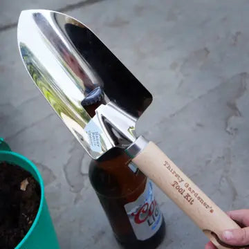 Bottle Opener Trowel with wooden handle and leather cord, ideal for gardening enthusiasts.