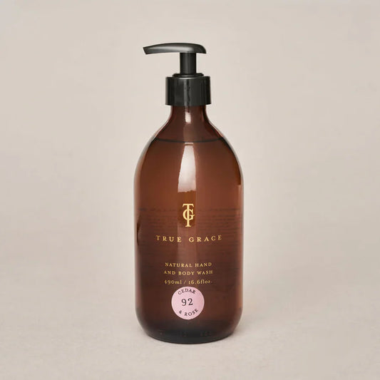 True Grace Cedar & Rose Hand & Body Wash in 490ml refillable amber glass bottle with pump.