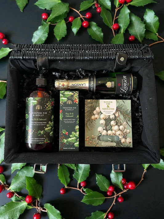 christmas festive gift hamper with mini champagne, festive soap and hand cream and chirstmas scented tea lights