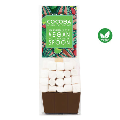 Cocoba marshmallow hot chocolate spoon in a clear plastic bag with a green and multicolor label, showing white marshmallows stacked above a brown chocolate spoon base, with a green vegan logo on the right.