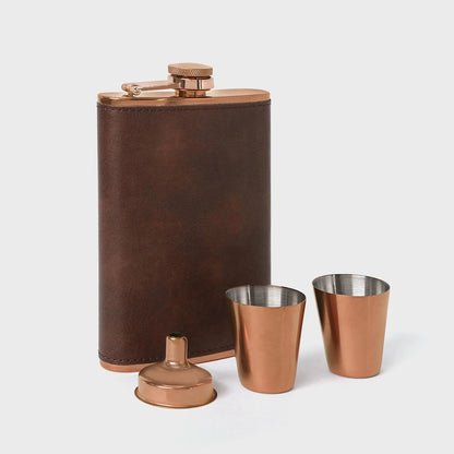 Copper hip flask set with brown faux leather, includes funnel and shot cups.