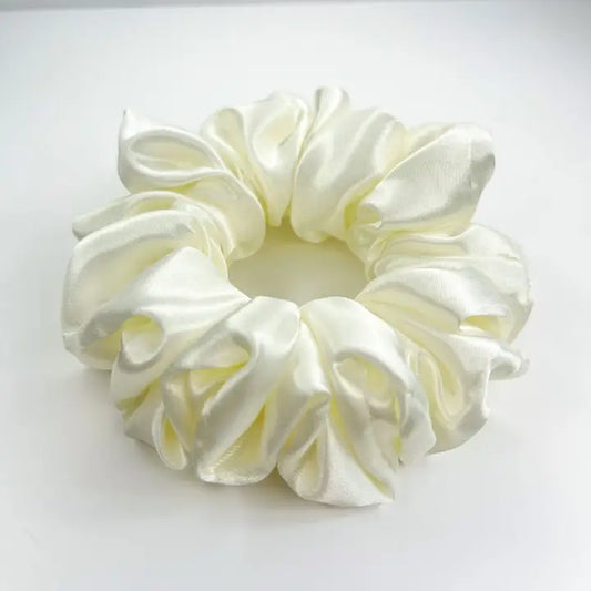 Cream satin scrunchie for stylish, healthy hair.