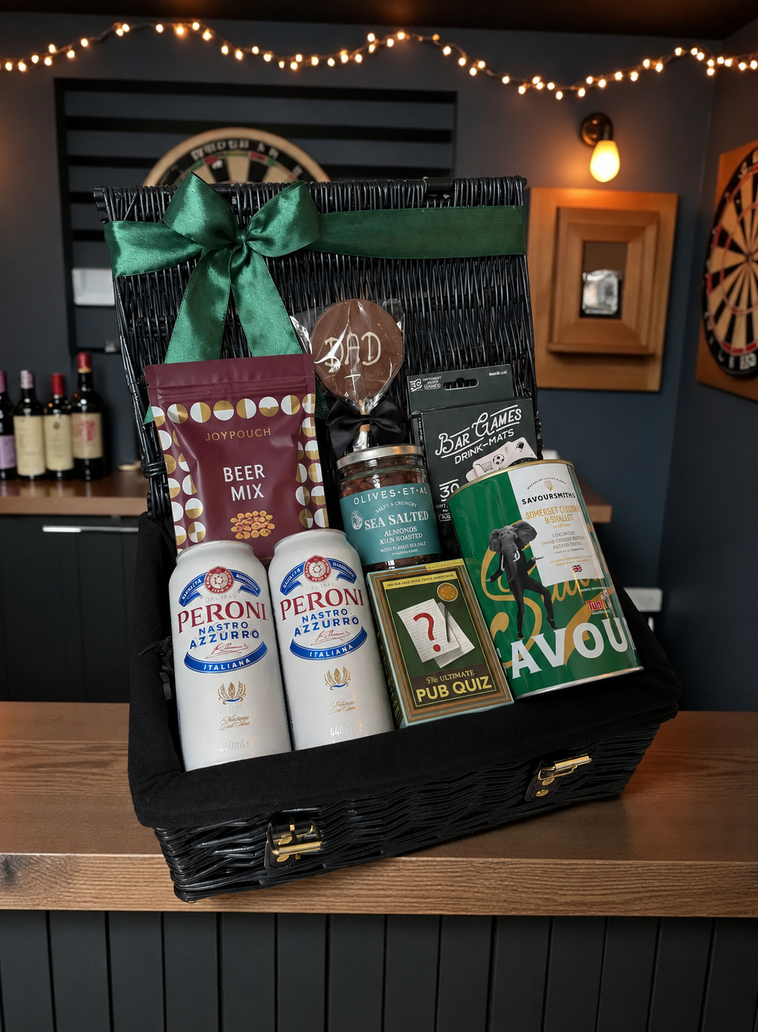 Gift basket with beer bottles and snacks on a wooden table.