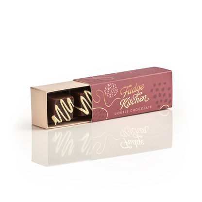 Fudge Kitchen Double Chocolate Fudge in a burgundy gift box with white chocolate drizzle.