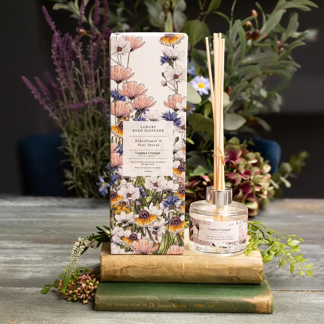 Elderflower & Pear Presse Diffuser in floral gift box on display with plants.