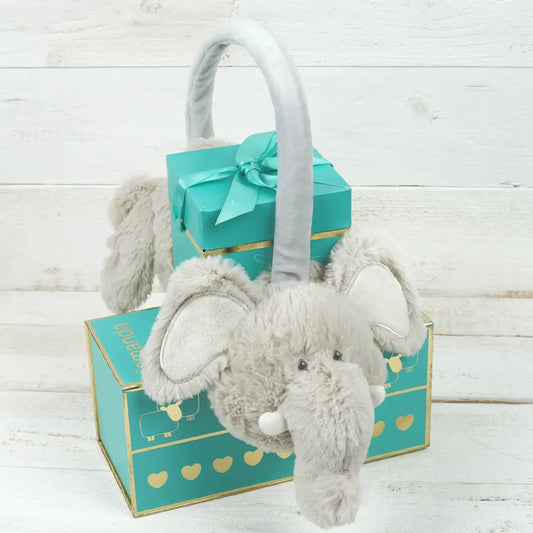 Soft adjustable elephant earmuffs with plush design displayed in front of a decorative gift box.