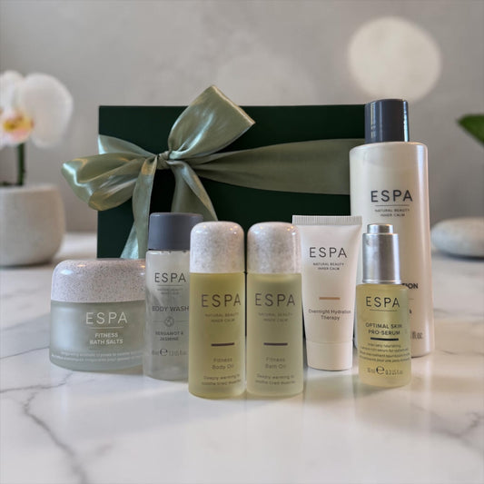 Espa skincare products on a marble surface with a decorative box in the background.