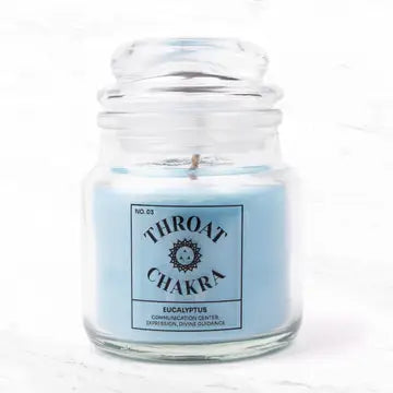 Throat Chakra Candle in glass jar with eucalyptus scent for communication and relaxation.