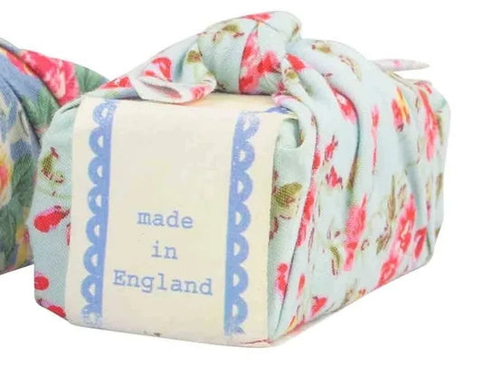 Turquoise floral fabric wrapped soap made in England.