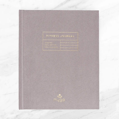 Suede hardcover fitness journal for tracking progress and goals.