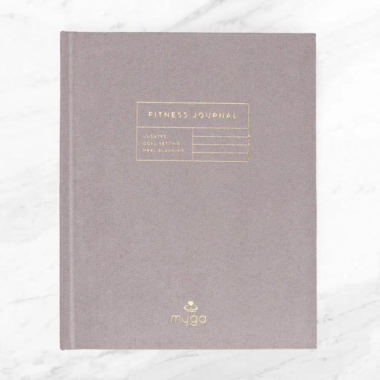 Suede hardcover fitness journal for tracking progress and goals.