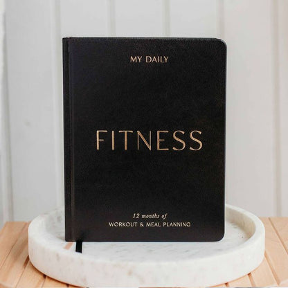 Black Daily Fitness Planner in elegant vegan leather cover on display.