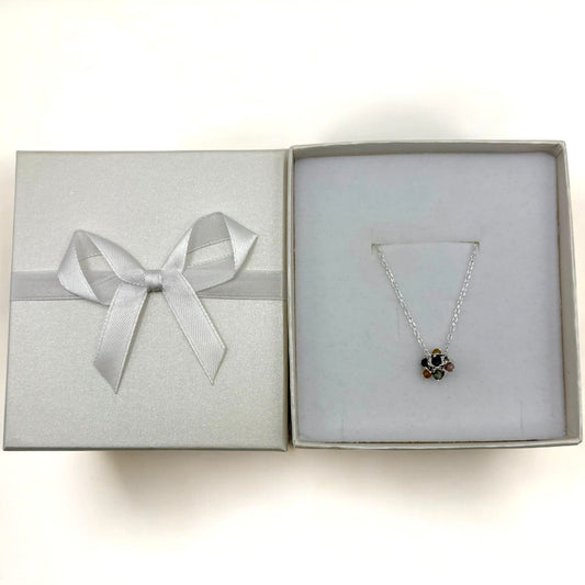 Delicate silver necklace with a cluster of forget-me-not flowers.