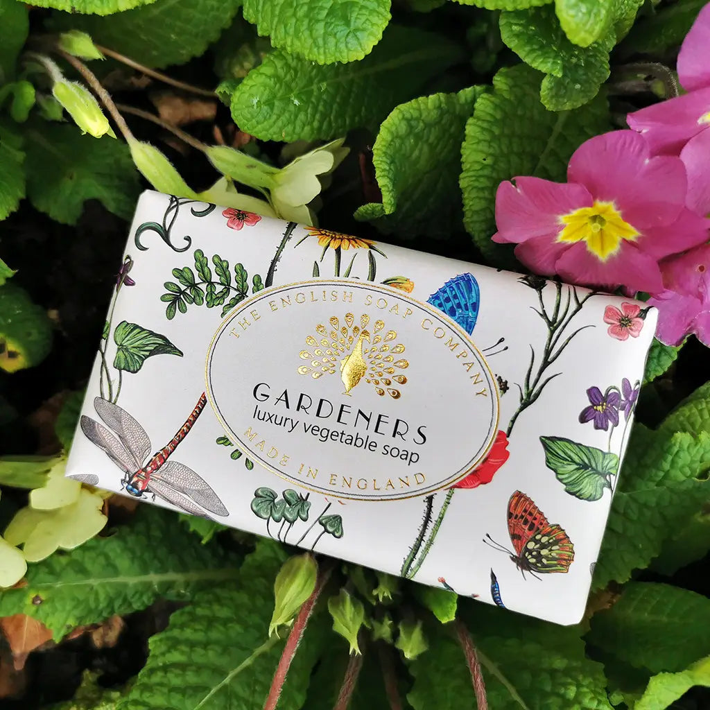 Soap bar with botanical design and 'Gardeners' branding on a green leafy background