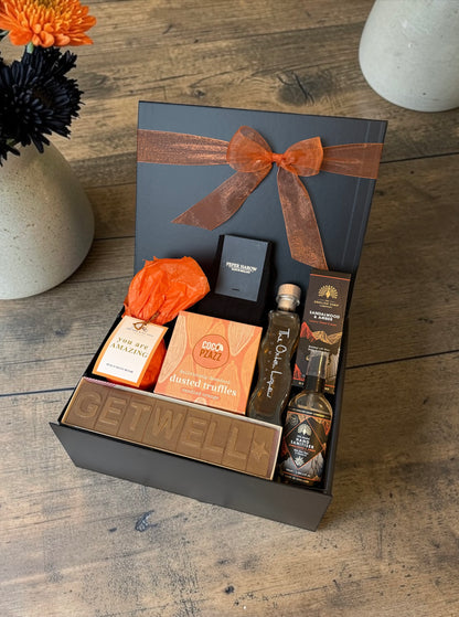 Get well gift hamper with truffles, rhubarb gin liqueur, hand cream, diffuser or bath bomb and Peper Harow socks.