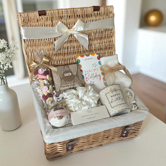 Gift basket with birthday-themed items on a table