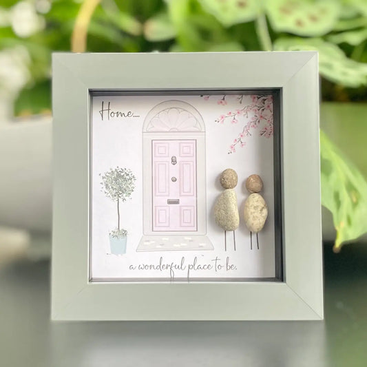 Mini pebble artwork in a frame with a pink door design, ideal for a new home gift.