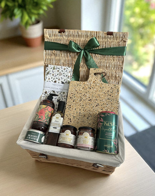 homely gift hamper with chopping board, tea towel, hand soap, breakfast tea, oil, candle and condiments