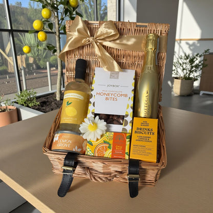 Lemon Grove gift hamper with Limoncello, honeycomb chocolate bites, cheese biscuits, lemon candle, citrus soap and prosecco option.