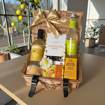 Lemon Grove gift hamper with Limoncello, honeycomb chocolate bites, cheese biscuits, lemon candle, citrus soap and cloudy lemonade option.