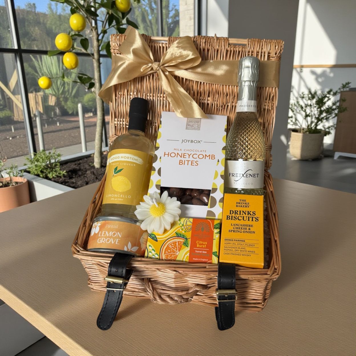 Lemon Grove gift hamper with Limoncello, honeycomb chocolate bites, cheese biscuits, lemon candle, citrus soap and prosecco option.