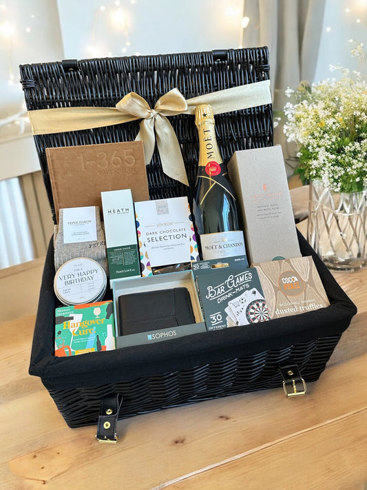 Luxury sparkling birthday hamper with Moët & Chandon, leather wallet, socks, journal, shower steamers, candle, hand salve, body wash, bar games, chocolates, truffles.