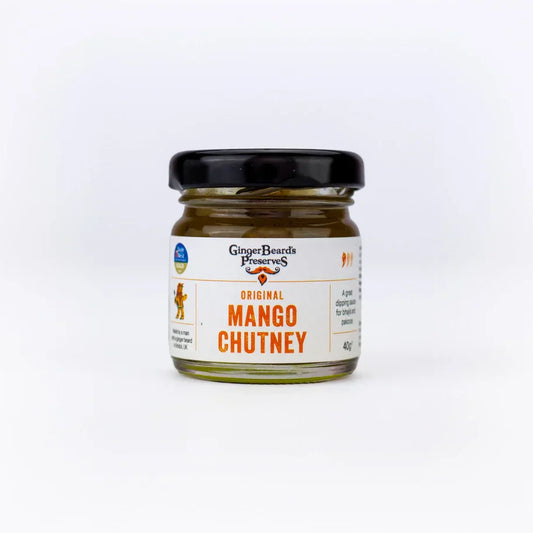 Miniature jar of sweet and tangy mango chutney condiment.