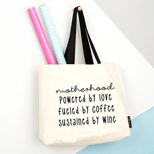 Humorous 'Motherhood, Powered By Wine' large tote bag with thick canvas and strong handles.