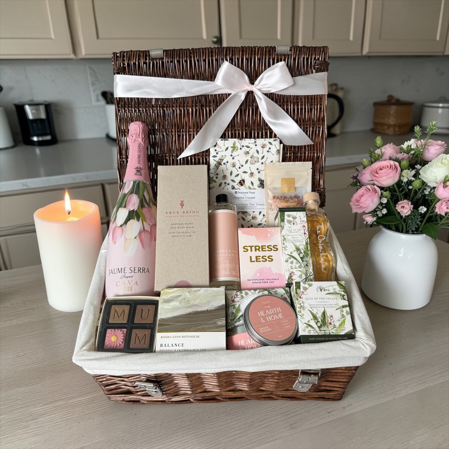 Mum’s luxury gift hamper with sparkling wine, skincare, candles, chocolates, bath salts and pamper items.