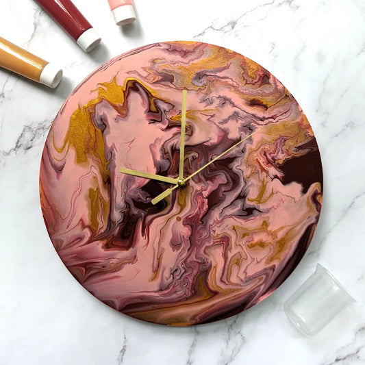 Paint Pouring Wall Clock with golden hands and acrylic background in a craft kit.