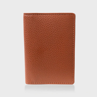 Pebble grain leather passport holder in tan.