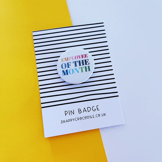 Employee of the Month pin badge on striped card background.