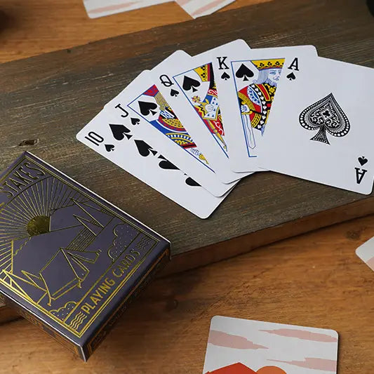 Wild and Free playing cards displayed on a wooden table.