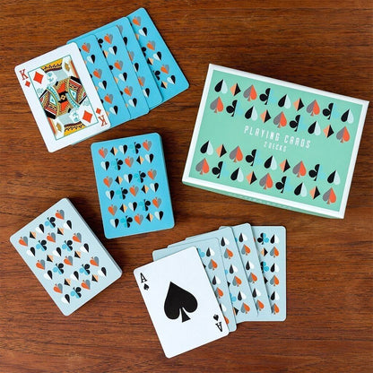 A deck of playing cards labeled 'Playing Cards 2046' arranged on a wooden table, with several cards fanned out and card backs visible. 