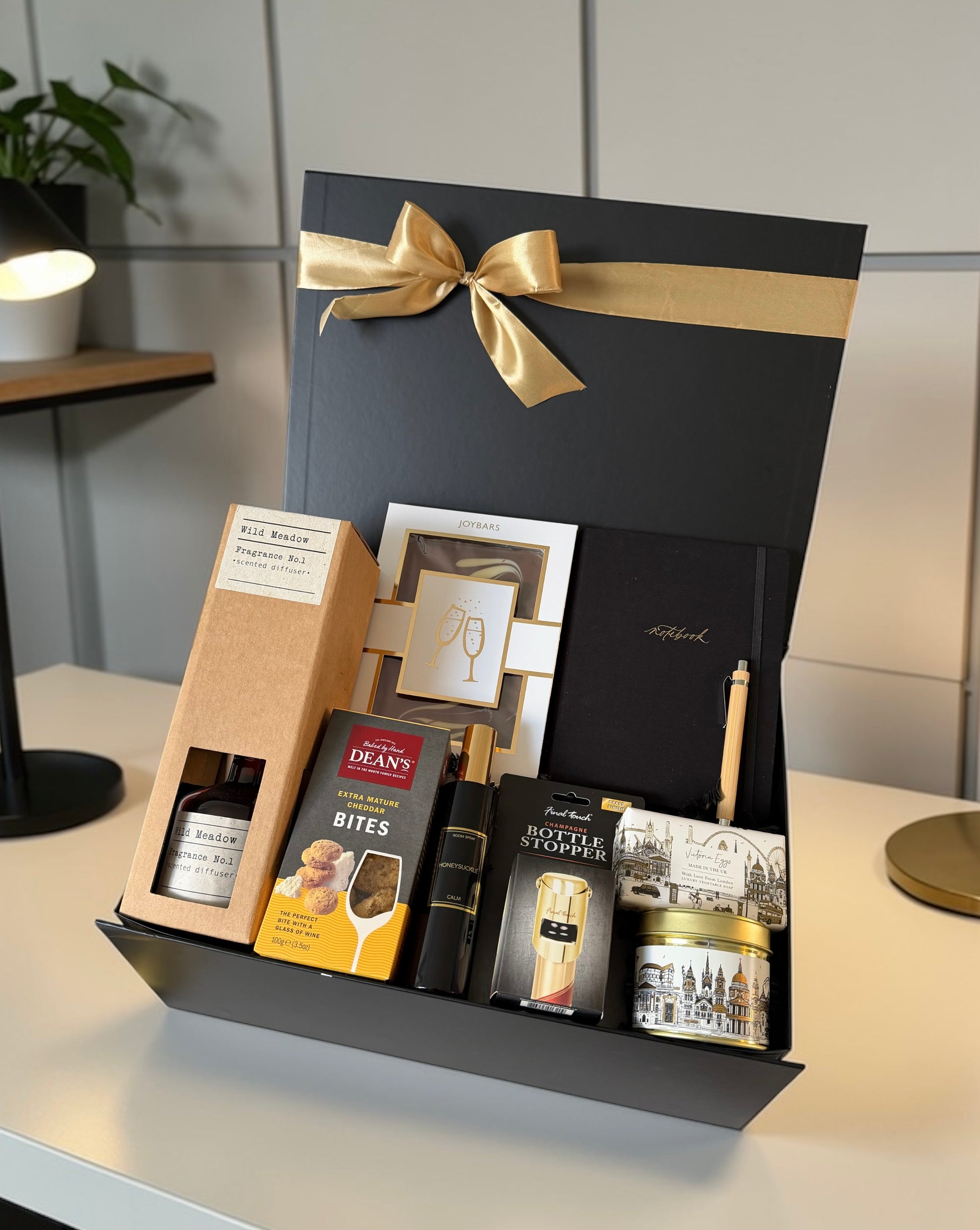 Premium congratulations gift hamper with chocolate, notebook, reed diffuser, gourmet cheese bites.