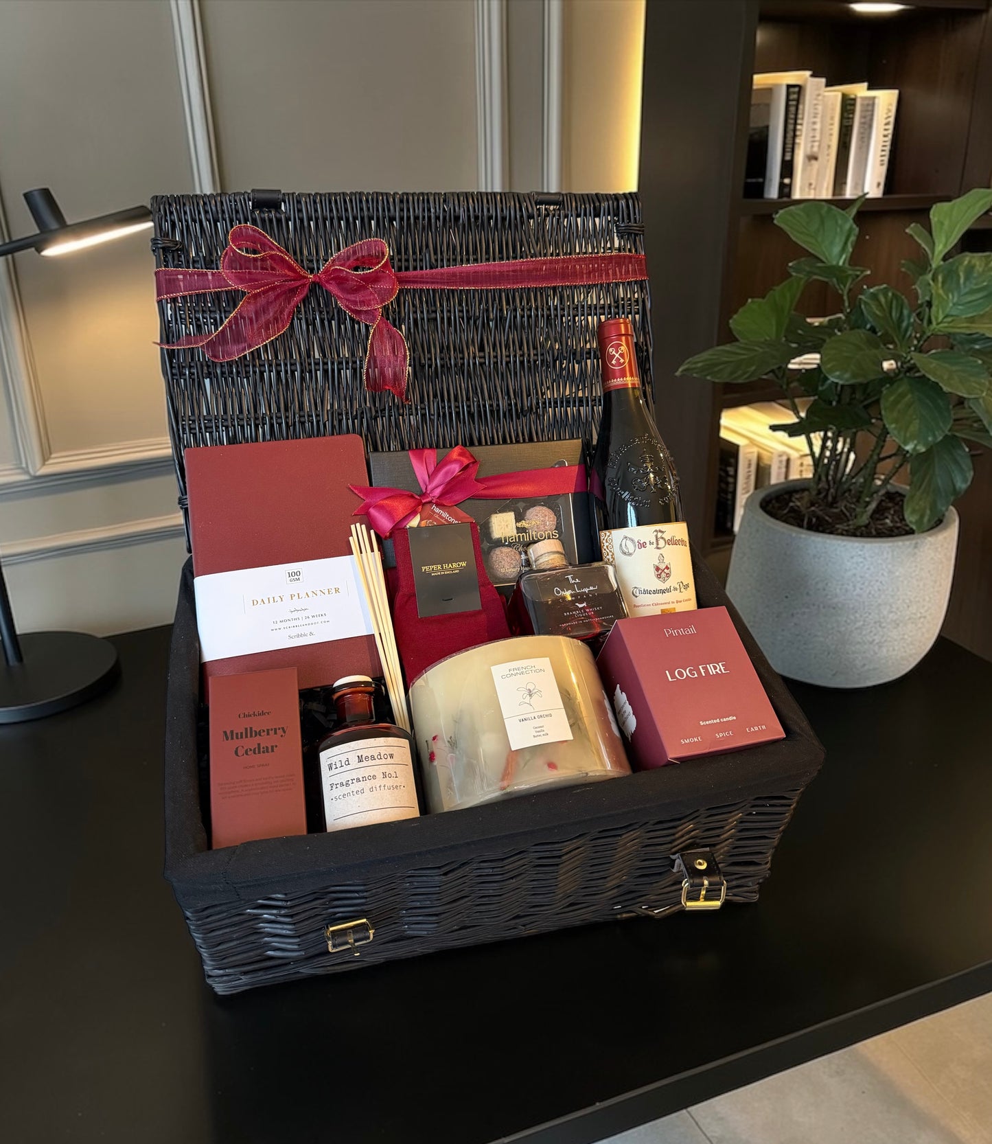 Luxury gift hamper with productivity planner, candles, reed diffuser, chocolates, whiskey and choice of fine wine or Champagne.