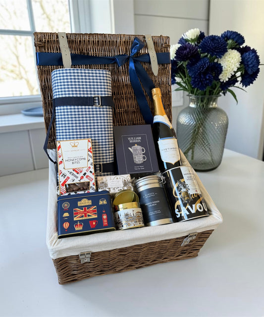 quintessentially english hamper with British gourmet goodies, tea pot set, english sparkling wine, hand soap and candle