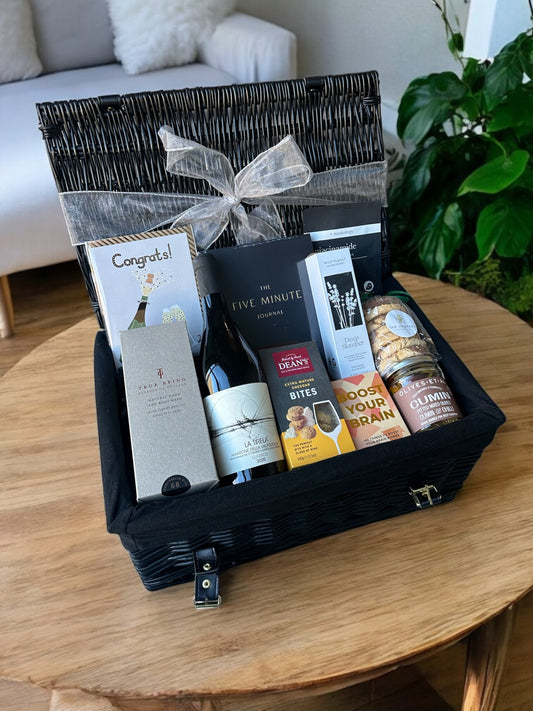 Luxury retirement hamper with Amarone wine, body wash, aromatherapy spray, trivia cards, snacks, and biscuits.