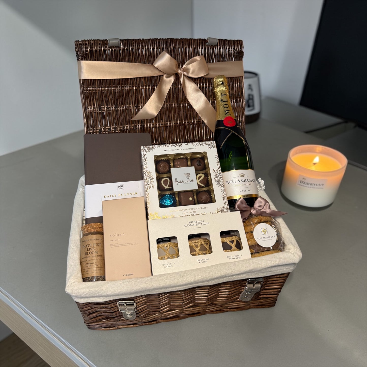 Luxury retirement gift hamper with chocolates, biscuits, reed diffuser, home spray, seed bombs and Champagne option.